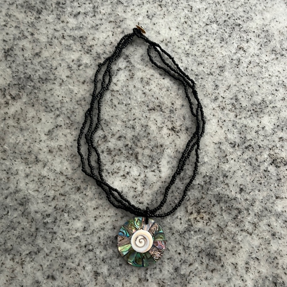 Necklace.  She’ll with black beads.  Clasp.  Choker.  Summer style.